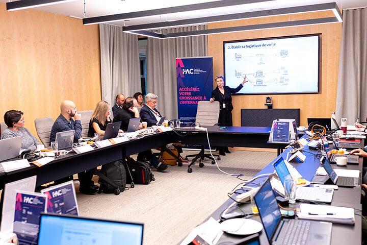 Participants gathered in a training room during a Trade Accelerator Program presentation.